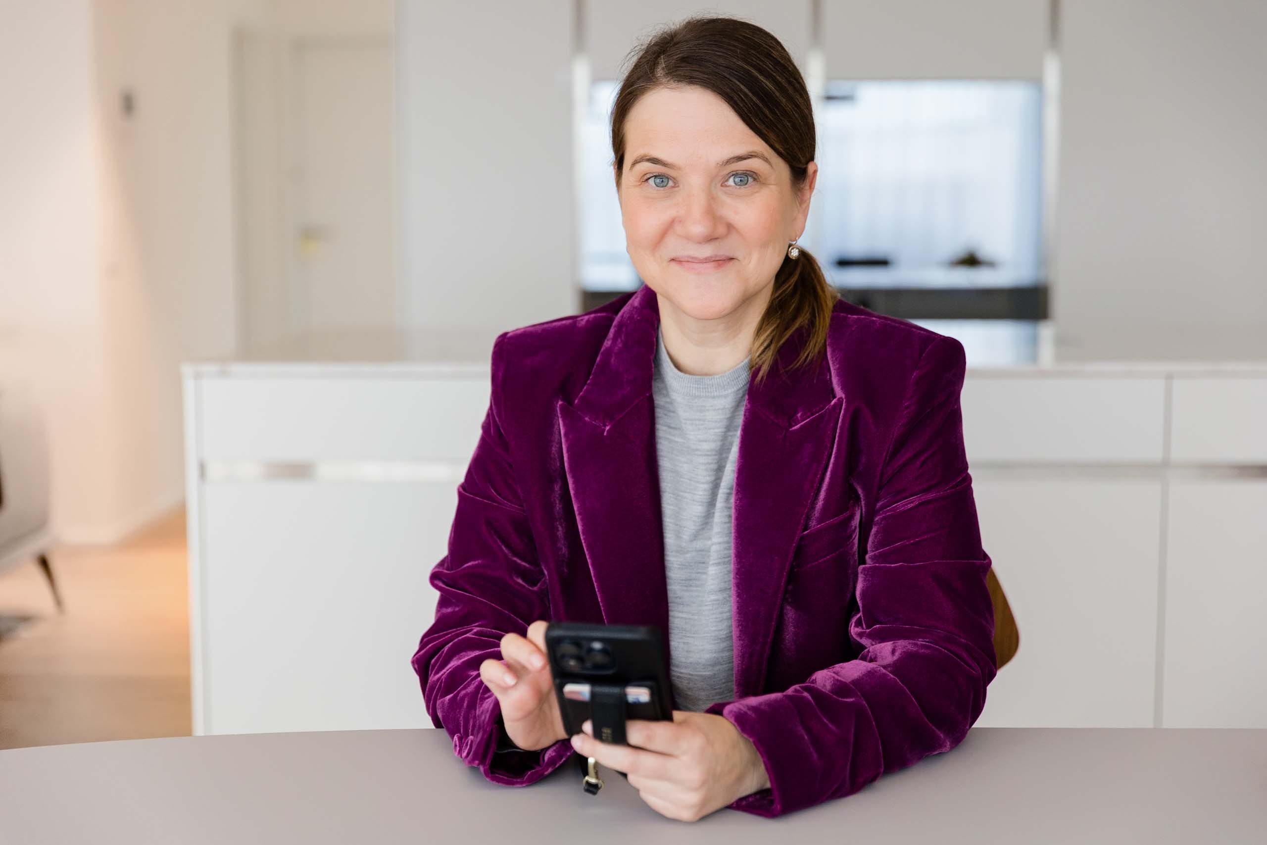 Frau mit Telefon am Tisch